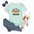 Flat lay of a mint green t-shirt with sunshine graphic and casual styling accessories - S / Sky Blue
