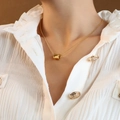 Polished 18K gold cylinder pendant necklace on fine snake chain worn by a female model - Necklace(40+5cm) / Gold