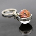 Detailed view of Eiffel Tower glass ball keychain with artistic sunset scene on black reflective background - Fantasy Sunset Style (JY007582-14)