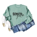 Flat lay of mint green crewneck sweatshirt with just a small town girl print and denim - Light Green (Black Font)