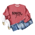 Flat lay of vintage red sweatshirt with 'just a small town girl' print and heart detail - Red (Black Font)
