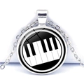 Detail of the piano key heart pattern under a glass dome on this stainless necklace - Domed Black White Piano Keys Style (JY007513-11)