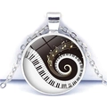 Detailed close-up of piano key heart necklace with golden musical notes and silver chain - Dynamic Spiral Piano Keys Style (JY007513-8)