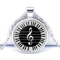 Detail view of heart piano keys and treble clef musical glass dome pendant - Encircled Treble Clef Piano Style (JY007513-7)