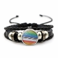 Detail of woven leather bracelet with rainbow piano key cabochon and adjustable cord - Rainbow Background Piano Keys Style (JY007515-10)