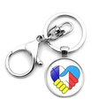 Close-up of silver metal keychain with lobster clasp and heart-shaped flag glass pendant - Shaking Hands Heart Gem Style (XSWX4486-15)