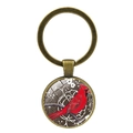 Detailed close-up of a bronze vintage keychain featuring a red cardinal bird glass dome - Line Drawing Floral Style (XSWX4976-11)