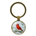 Detailed close-up of a bronze cardinal bird glass cabochon keychain with a pine branch - Realistic Bird On Pine Style (XSWX4976-6)