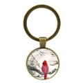 Macro detail of cardinal bird keychain with bronze metal frame and glass dome charm - Painted Snow Branch Style (XSWX4976-4)