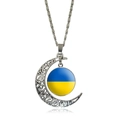 Silver hollow moon pendant necklace featuring Ukraine flag glass gem on white background - Ukraine