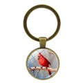 Vintage bronze keychain with cardinal bird artwork under a magnifying glass dome - Standing In Snow Style (XSWX4976-1)