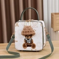 Detail of white box bag featuring a 3D teddy bear with a brown knit hat and green handle - Beige/Green