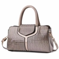Close-up of champagne crocodile pattern handbag featuring Y-shaped patent leather detail - Gray