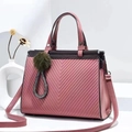 Pink embossed tote bag with V-pattern, crossbody strap and green pompom charm - L28cm x H22cm x W15cm / Pink