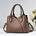 Detail of dark brown lychee leather bag with gold hardware and V-shaped stitching - Brown
