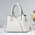 Detail of white faux leather handbag showing fine litchi texture and gold hardware - Off White