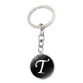 Porte-clés en métal argenté avec un pendentif rond noir orné de la lettre T en blanc - Lettre T