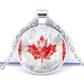 Detailed close-up of a circular pendant featuring a distressed Canadian flag design - Retro Artistic Maple Leaf (JY007841-8)