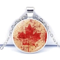 Detailed close-up of a vintage Canadian flag necklace with maple leaf glass cabochon - Distressed Maple Leaf (JY007841-7)