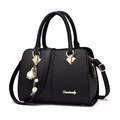 Classic black litchi texture handbag with gold hardware and floral pearl pendant - Black