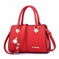 Elegant red leather handbag with gold accents and detachable shoulder strap for women - Red