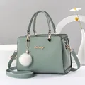 Green leather tote bag with top handles, crossbody strap and white plush pom-pom - 24cm x 13cm x 18cm / Green