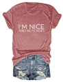 Close-up of I'M NICE letter print on brick red cotton t-shirt with denim shorts - Rose Gold (White Font)