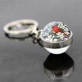 Macro shot of double-sided glass ball keychain with red cardinal bird and white flowers - Cardinal in White Flowers Style (JY007882-9)