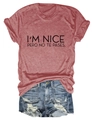 Flat lay of a red t-shirt with I'M NICE print and distressed blue denim shorts set - Rose Gold (Black Font)