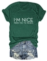 Flat lay of dark green T-shirt with I'M NICE PERO NO TE PASES text and denim shorts - Retro Green (White Font)