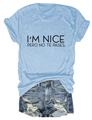 Detail of I'M NICE PERO NO TE PASES slogan print on light blue tee and denim shorts - Light Blue (Black Font)