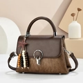 Vintage brown crossbody bag with striped texture and star pendant on geometric backdrop - Coffee