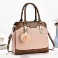 Detailed shot of leather crossbody bag with pink and brown color block and gold hardware - Pink