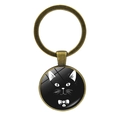 Macro detail of bronze pendant keychain with glass cabochon featuring a black cat design - Black Cat with Bowtie Style (JY007899-5)