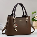 Brown lychee pattern leather handbag with gold hardware and stylish charm pendant - Coffee