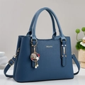 Deep blue litchi pattern handbag with dual handles and nautical theme pendants - Blue