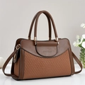 Detail of brown patchwork handbag with woven texture, golden hardware and fashion logo - Earthy Yellow
