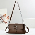 Detail of a brown leather shoulder bag with silver buckle and metallic chain strap - Coffee