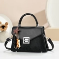 Detail of black crossbody bag featuring mixed textures, silver buckle, and star pendant - Black