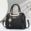 Elegant black handbag with herringbone pattern fabric and golden hardware details - Black