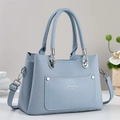 Light blue woven textured tote bag with top handles and adjustable shoulder strap - Blue