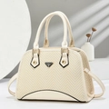 Close-up of beige woven shell bag featuring herringbone pattern and gold hardware - Off White