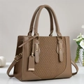 Detailed view of woven texture and smooth khaki leather on a stylish crossbody tote bag - Khaki