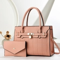 Detail of coral pink leather handbag set with metal padlock and matching wallet - Pink