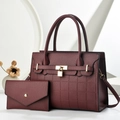 Close-up of wine red pebble leather handbag with gold metal lock and grid texture - Burgundy