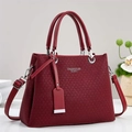 Close-up of wine red handbag with V-shaped woven texture and silver hardware - Red