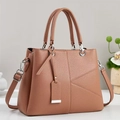 Classic caramel brown pebbled PU leather handbag with crossbody strap and geometric stitching - Pink