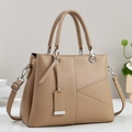 Detail of khaki leather handbag with geometric stitching and silver hardware accents - Khaki