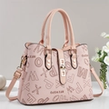 Light pink tote bag with letter print and gold clasp on a minimalist background - Pink