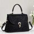 Chic black trapezoid handbag with gold horseshoe buckle shown from a 45-degree angle - Black